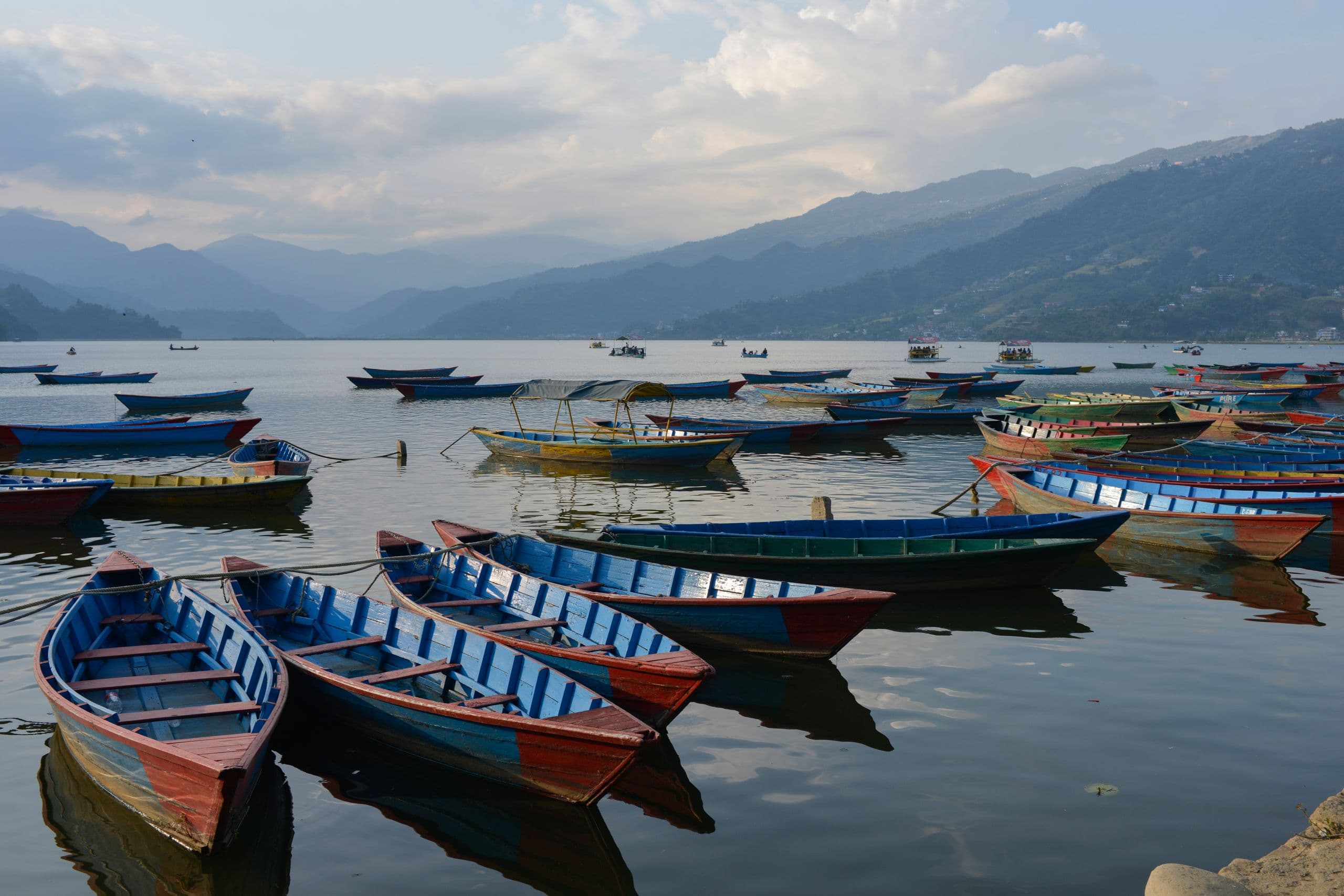 Colorful boats on Phewa Lake in Pokhara at sunset